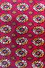 Khiva, Xorazm Region, Uzbekistan, Central Asia. Traditional red rug at the Khan palace. Art Print